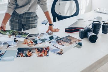 Woman standing at her desk and choosing the best images